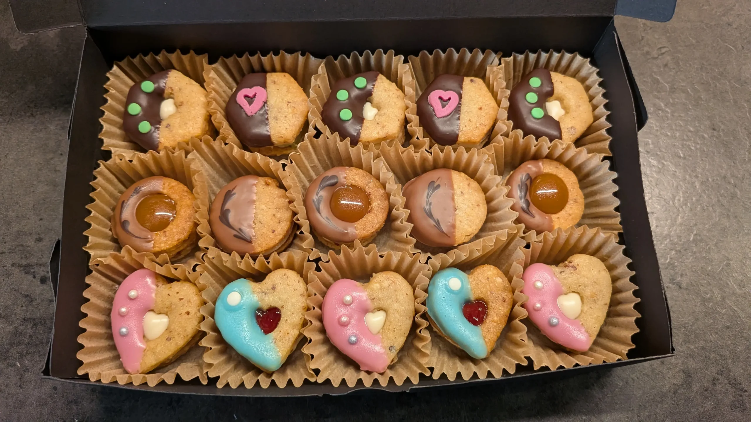Zusammenstellung verschiedener dekorierter Plätzchen in einer Präsentbox